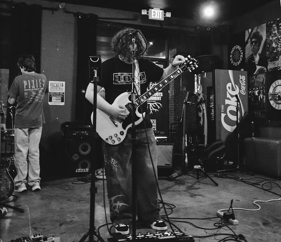 Guitarist tuning on a small club stage